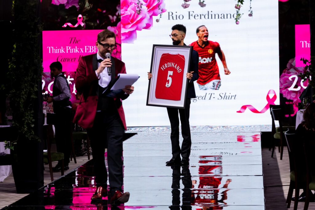 Auctioneer selling a framed signed Rio Ferdinand Manchester United shirt at a charity fundraising gala Auctioneer selling a framed signed Rio Ferdinand Manchester United shirt at a charity fundraising gala