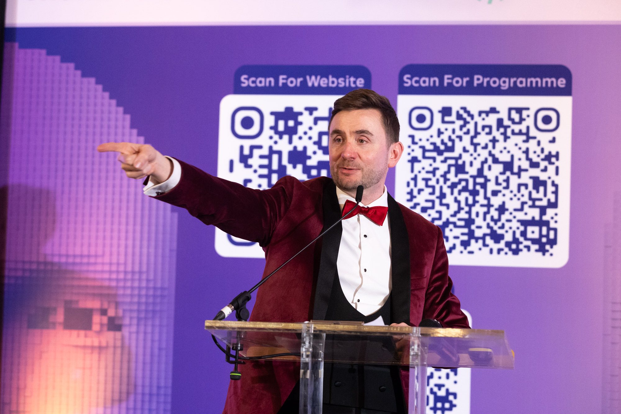 Charity auctioneer and event host Kevin Durham on stage at the AI Awards, presenting to the room from the podium Charity auctioneer and event host Kevin Durham on stage at the AI Awards, presenting to the room from the podium
