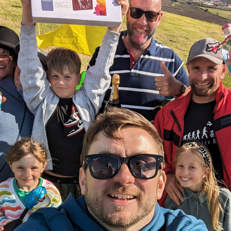 Kevin Durham celebrating with a group and children raising a glass at a charity event Kevin Durham celebrating with a group and children raising a glass at a charity event