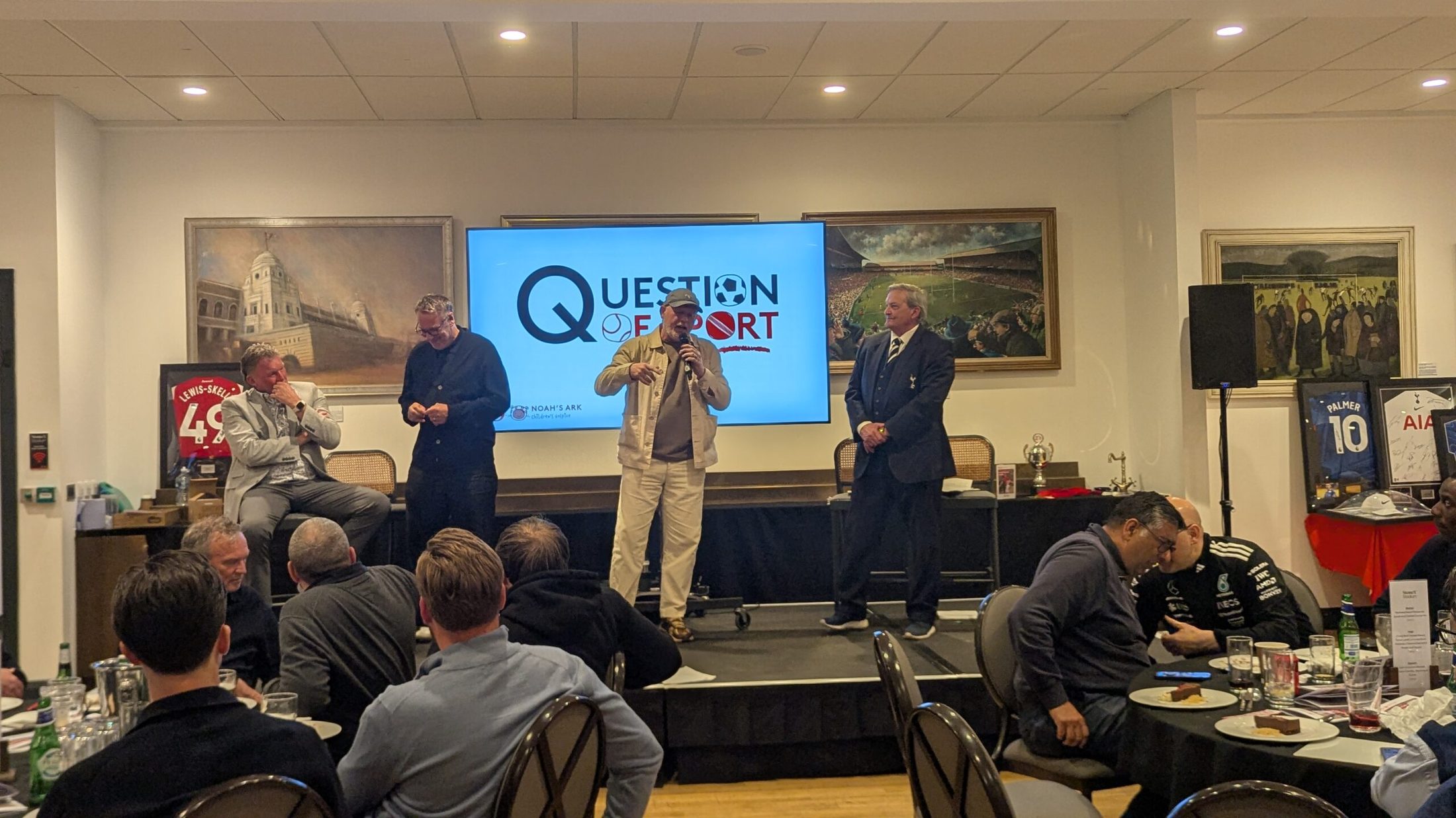 A professional charity auctioneer working the floor during a live auction. A professional charity auctioneer working the floor during a live auction.