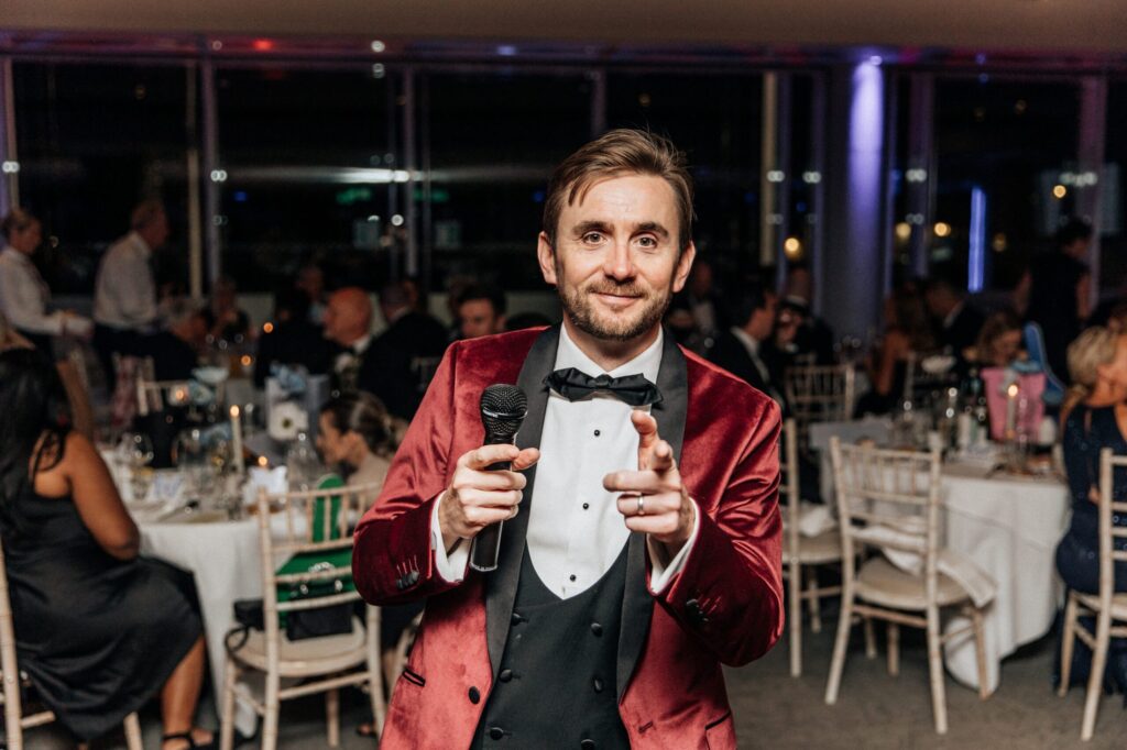 A professional charity auctioneer working the floor during a live auction. A professional charity auctioneer working the floor during a live auction.
