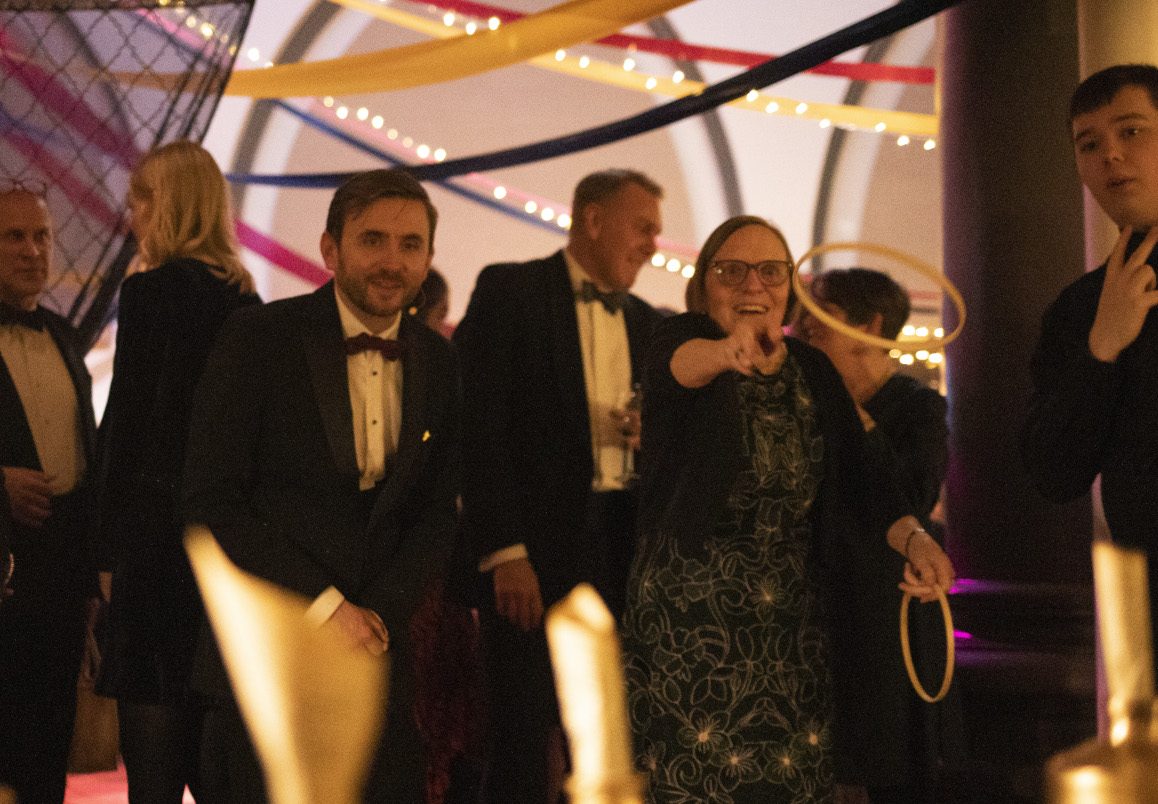 Guests playing an interactive game show at a black-tie gala hosted by Kevin Durham